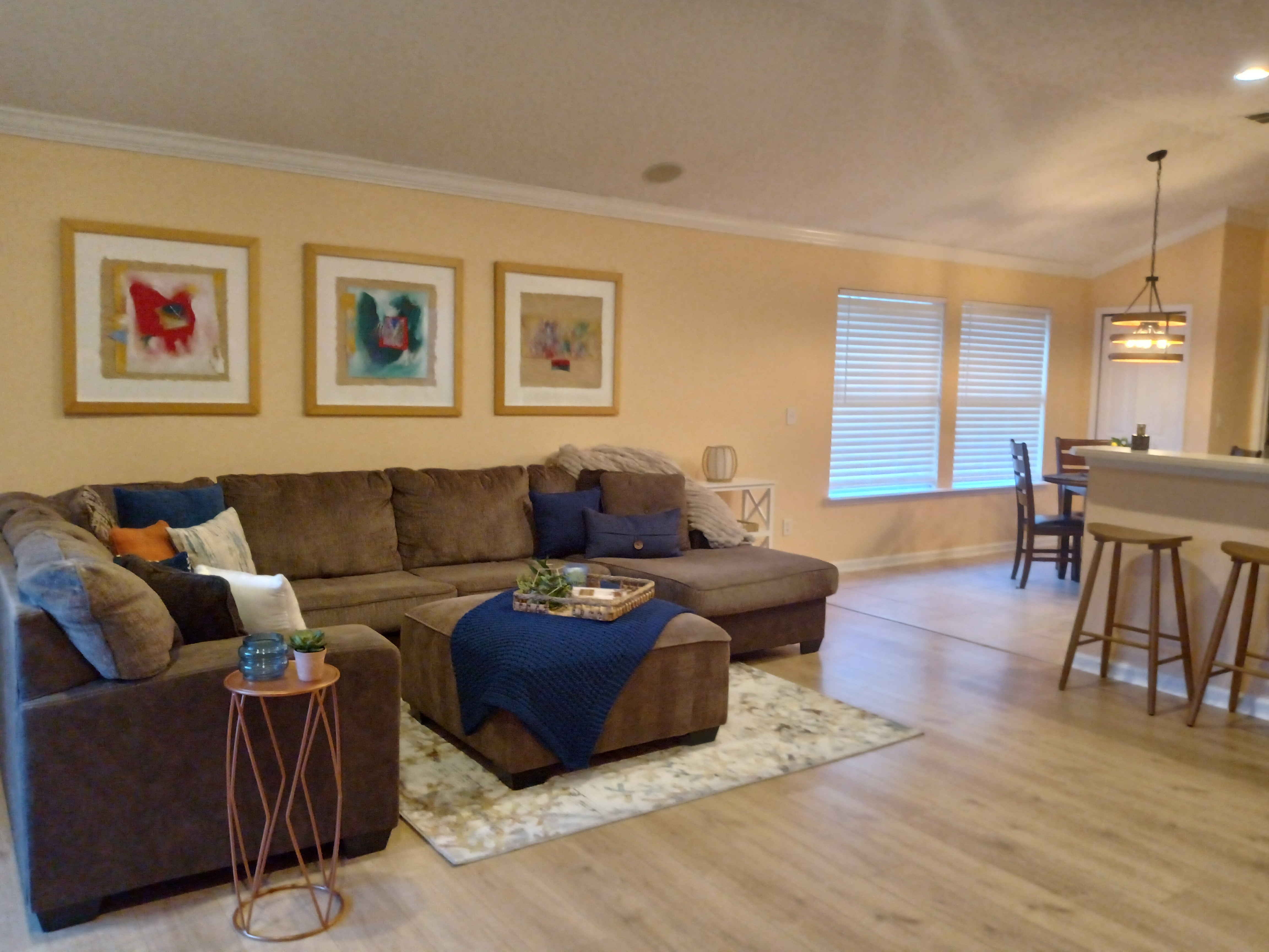 Living room with abstract painting collection displayed in gold frames