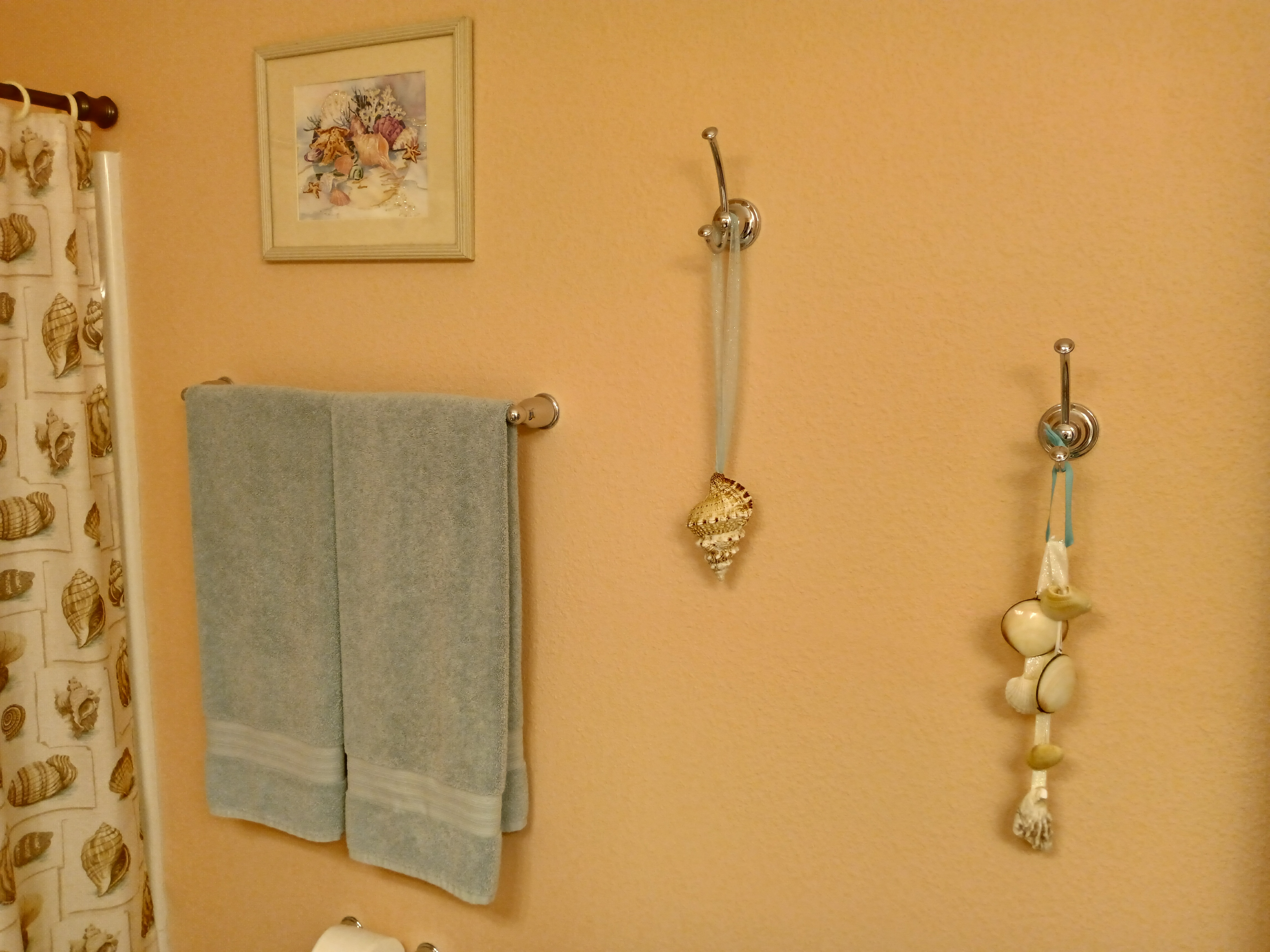 Coastal bathroom with seashell towels and shell accessories