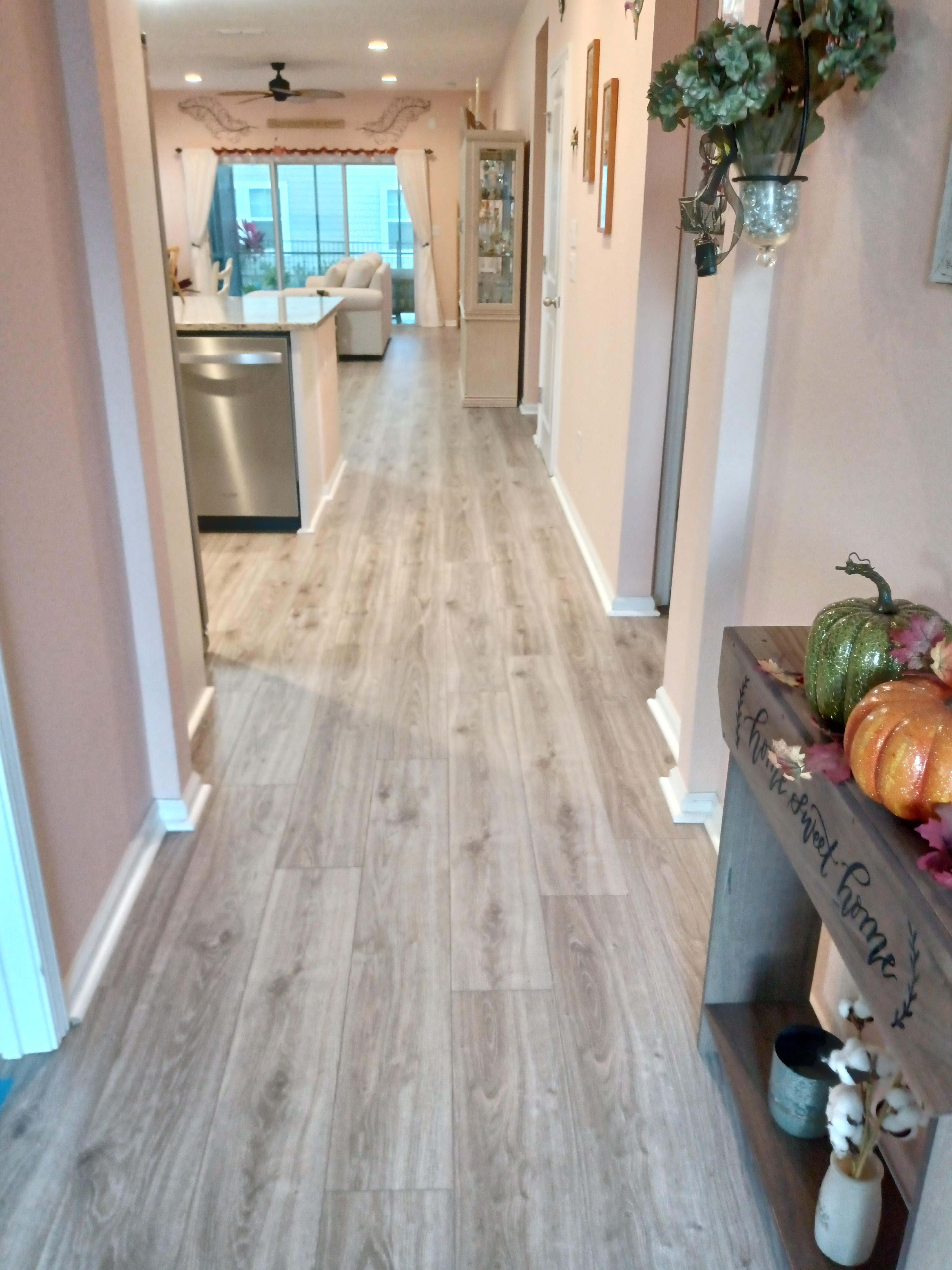 Fall hallway entryway with pumpkins and wood-look flooring